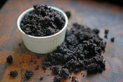 Chocolate crumbs from a cake in a white ramekin