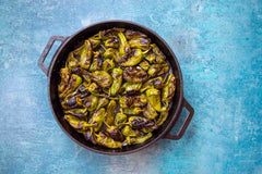 Blistered padrón peppers with flaked salt are the perfect handheld snack, easy to whip up and they will be gone in minutes.