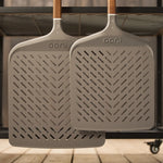 side by side of signature perforated pizza peel hanging from large modular table