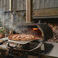 Ooni Karu 2 Pro Pizza oven with cooked pizza on peel