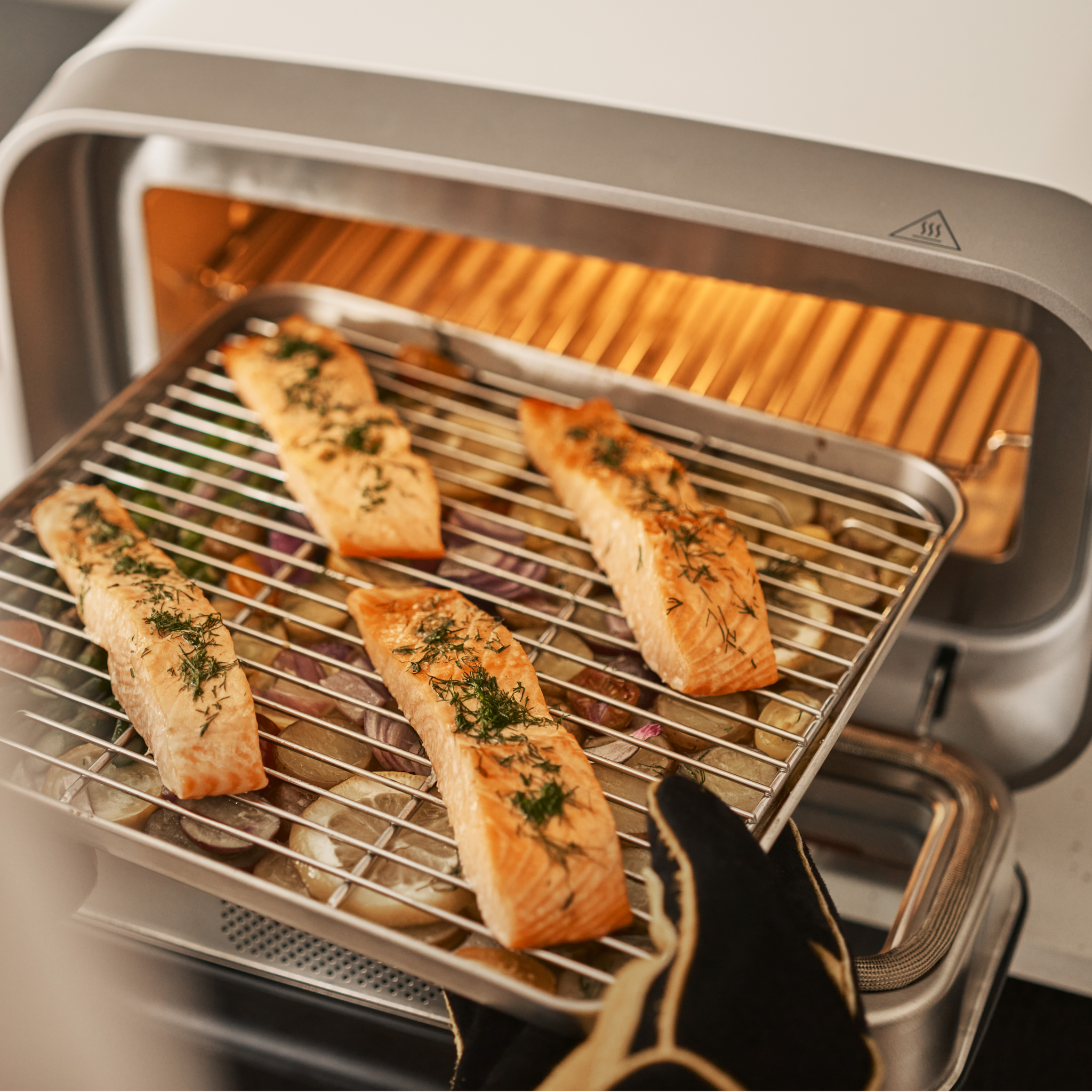 salmon fillets cooking on ooni sheet pan and rack in volt 2 electric pizza oven
