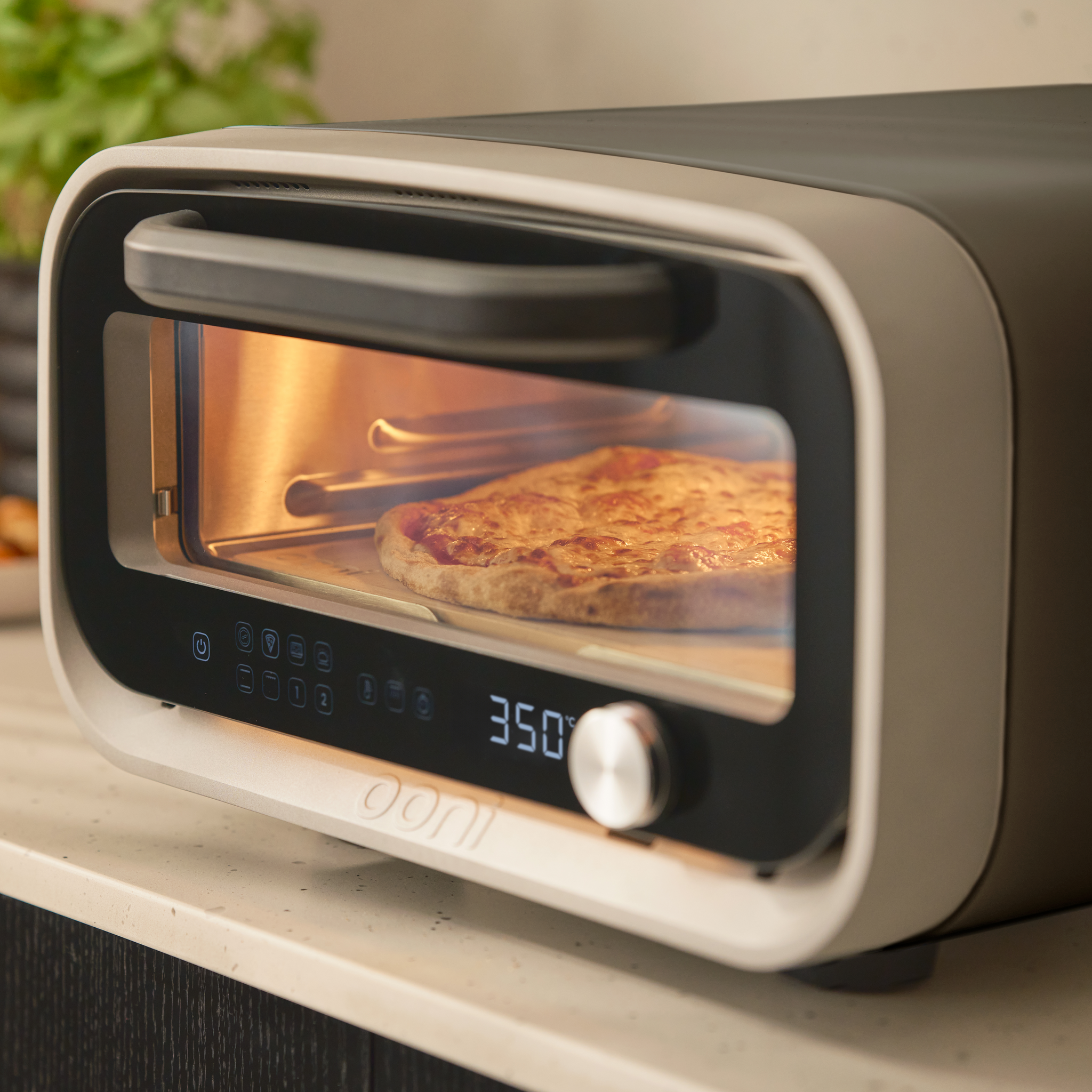 volt 2 electric pizza oven. close up with pizza cooking 